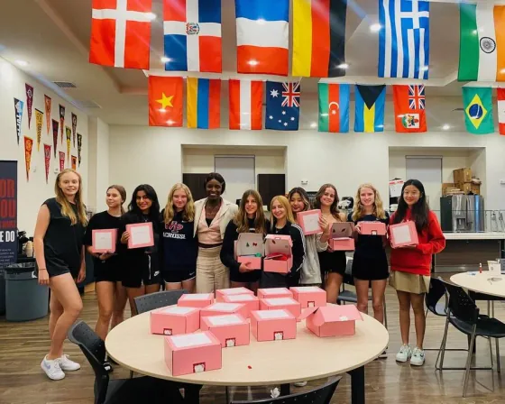 WPS PERIOD members holding the kits they packed
